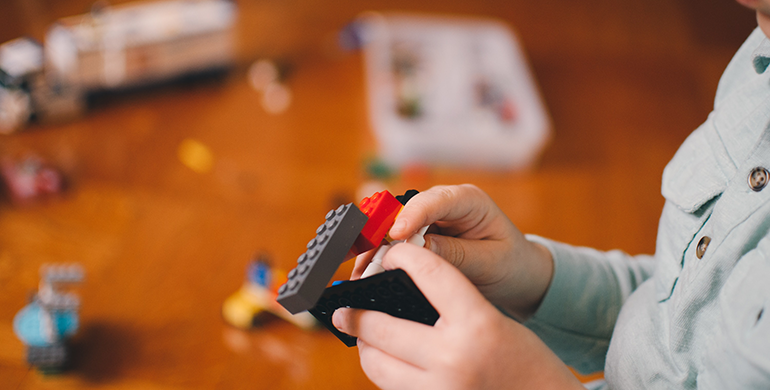 Child playing with LEGOS