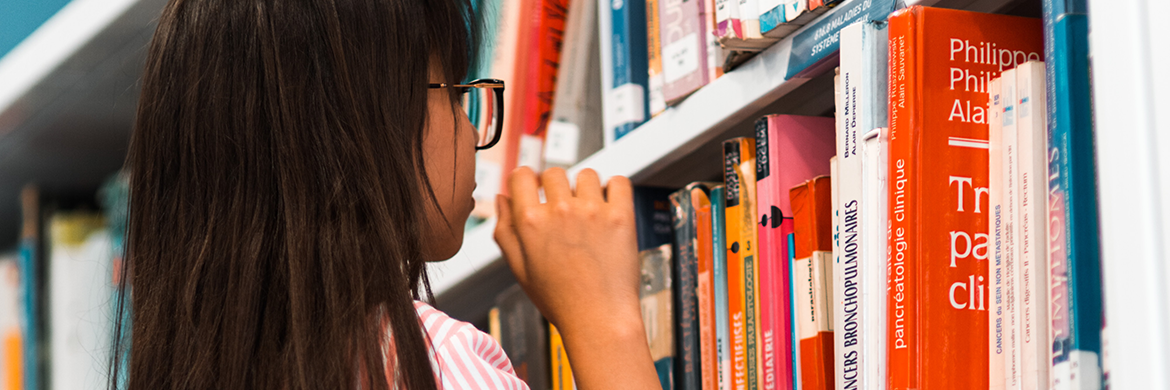 Young girl looking at books