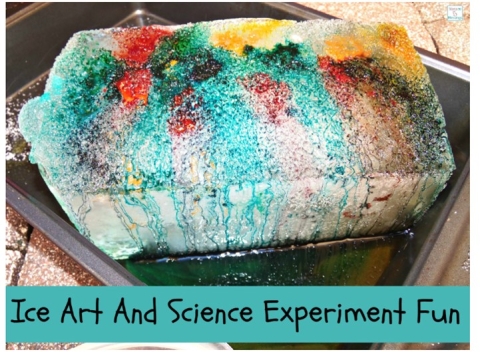 Large block of ice with different colors of paint on it.
