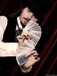 Magician in black top had fanning out playing cards