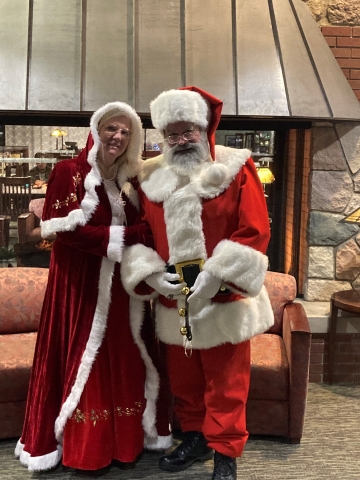 Santa and Mrs. Claus in front of the fireplace