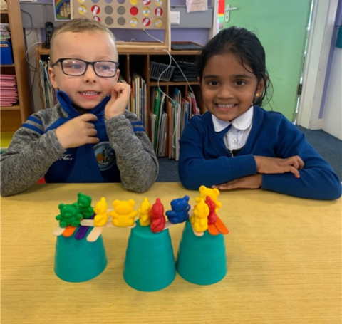 A boy and a girl looking at their lava-evading creation