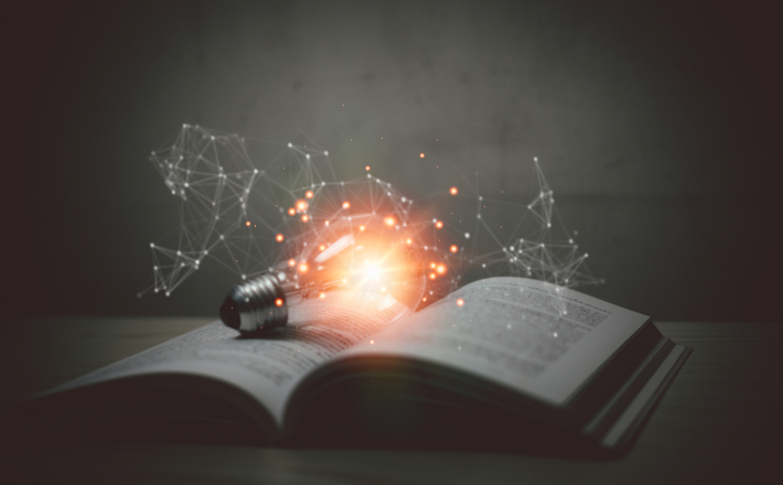 Open book with lightbulb on book